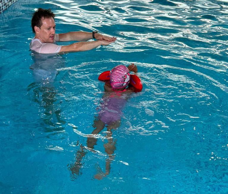 Paul and child learning to swim